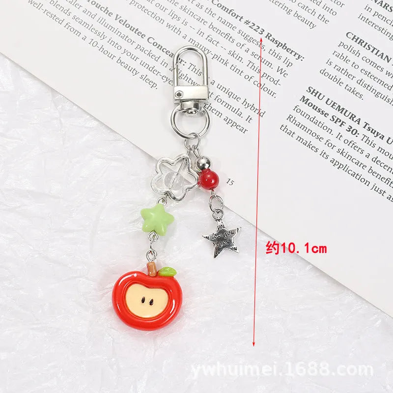 Plastic and resin fruit charm keychain with apple, strawberry designs on silver rope