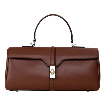 Women's cylindrical cowhide messenger bag in black with multiple internal compartments and shoulder strap