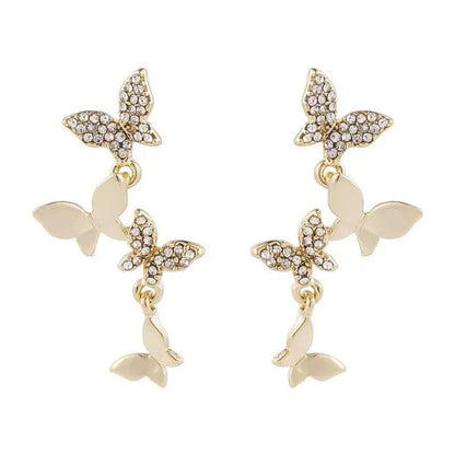 Women's gold copper butterfly drop earrings showing four-element dangle design