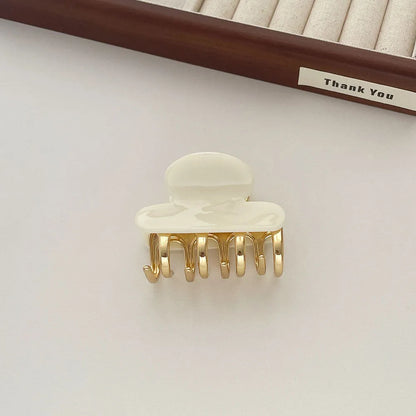 Acetate hair barrettes with metal alloy grip in leopard print, white, and ink colour options