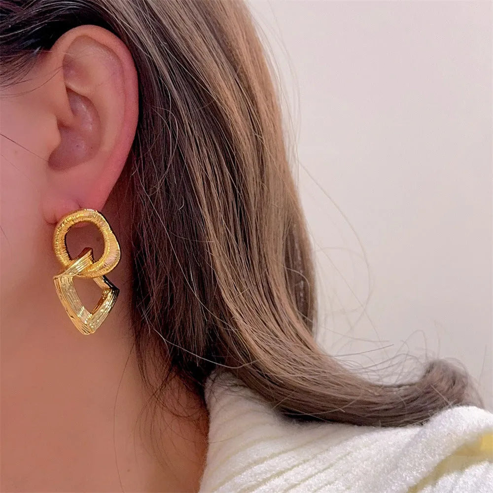 Copper geometry circle pendant earrings with electroplated gold finish measuring 3.4cm in height