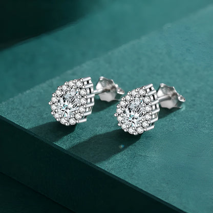 A pair of drop-shaped sterling silver ear studs with a diamond-cut finish.