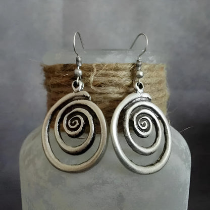 Retro geometric spiral earrings with a distressed silver finish.