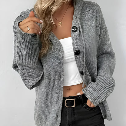 Loose fit grey hooded cardigan sweater with long sleeves on a hanger.