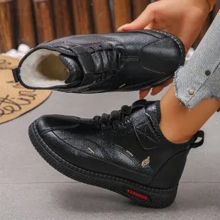 Women's black velvet indoor shoes with a non-slip rubber sole and low tube sock design.