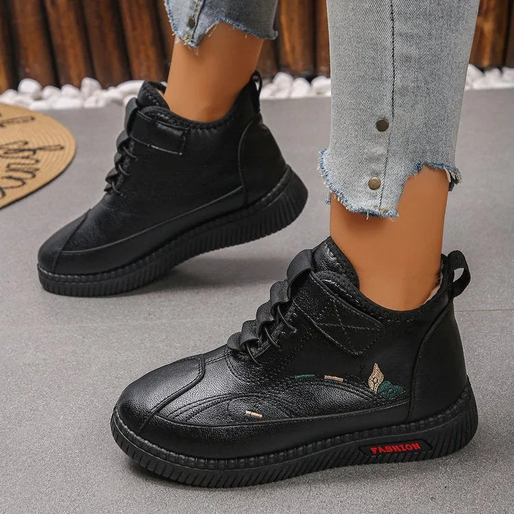 Women's black velvet indoor shoes with a non-slip rubber sole and low tube sock design.