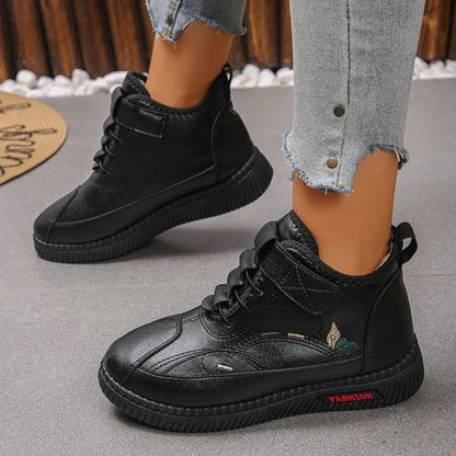 Women's black velvet indoor shoes with a non-slip rubber sole and low tube sock design.