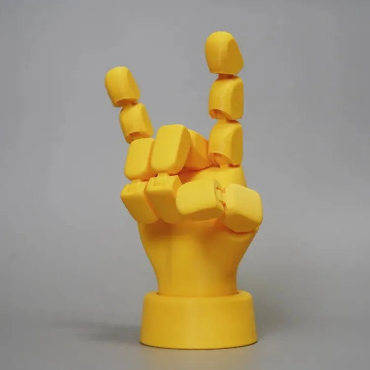 Yellow movable joint hand ornament showing articulated design and 5*5.38*7.5cm dimensions