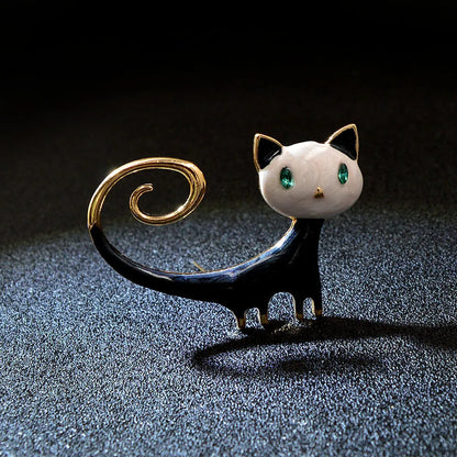 Women's alloy cat brooch with painted tailing up kitty design in white or orange colour