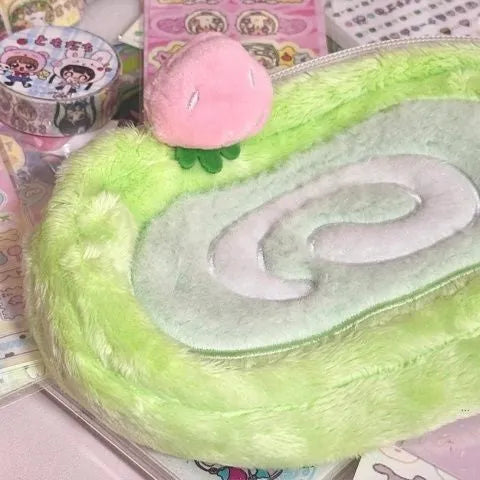 Honeydew Roll Plush velvet pencil case with Swiss roll cake design, showing roll-up style and soft texture for stationery storage.