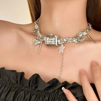 Dark women's layered necklace with twin chains, a cross pendant, and textured hemp-style links.