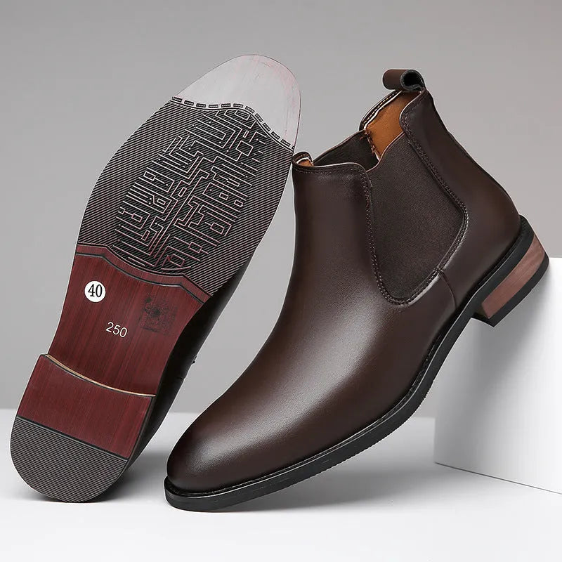 Men's black Chelsea boots with pointed toe design and sewing thread detailing on artificial PU upper