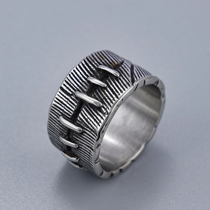 Dark geometric titanium steel punk ring showing U-shape and double ring design with stitched texture.