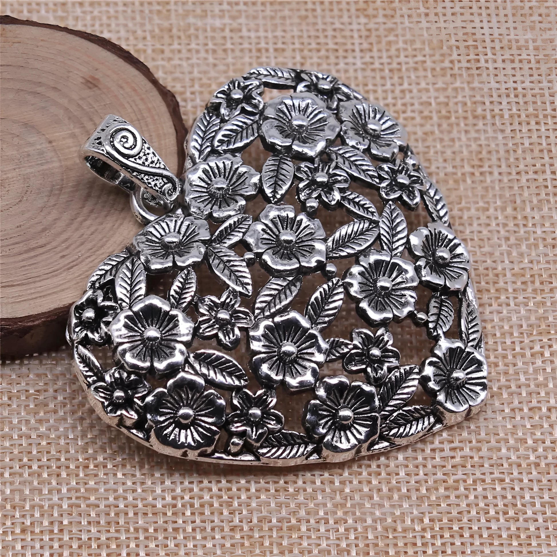 Hollow floral love pendant in ancient silver finish with European American styling