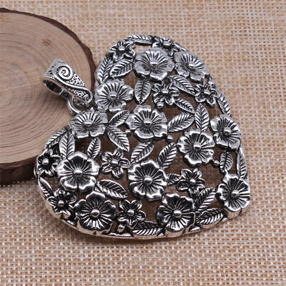 Hollow floral love pendant in ancient silver finish with European American styling