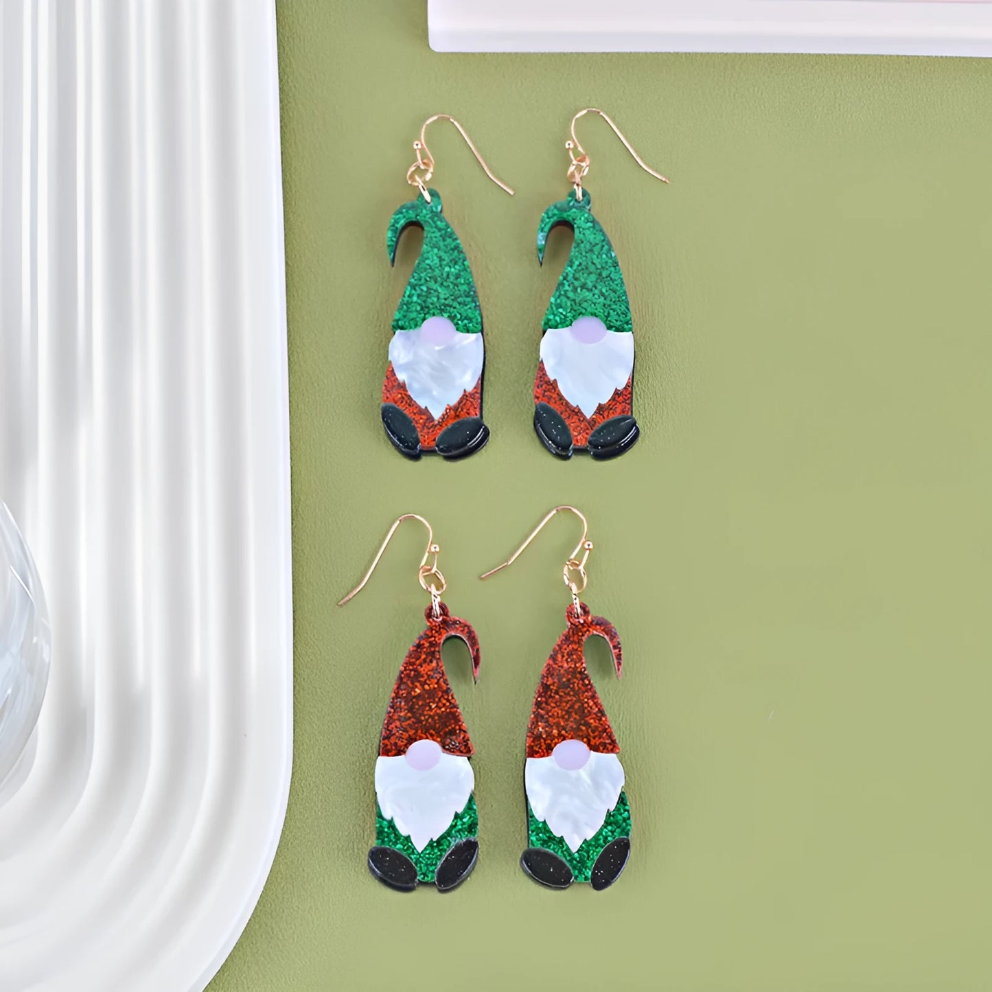 Acrylic Santa Claus cartoon character earrings in red, green, and red/green hat styles.