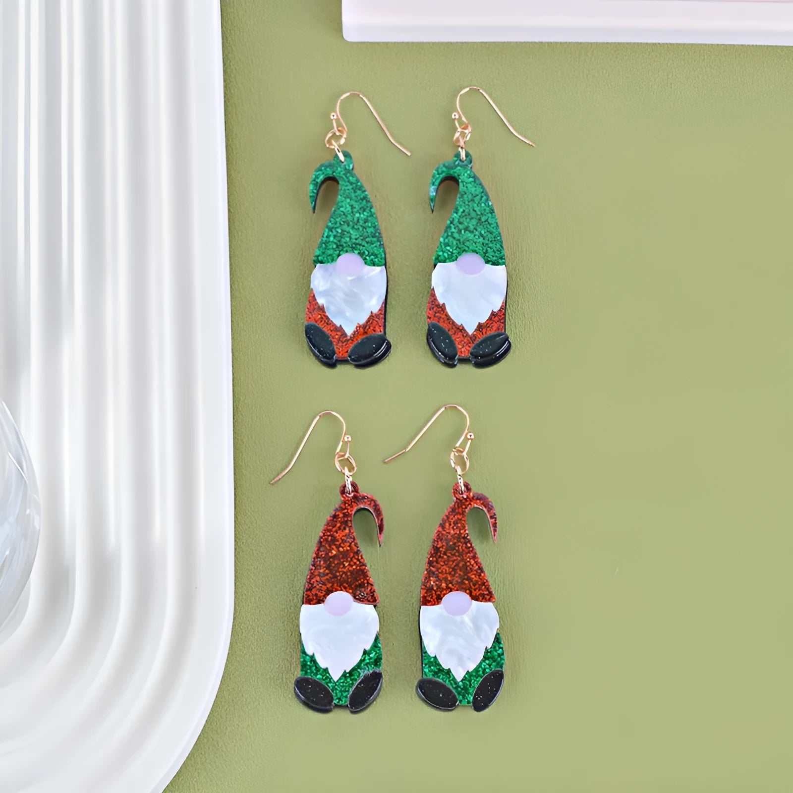 Acrylic Santa Claus cartoon character earrings in red, green, and red/green hat styles.