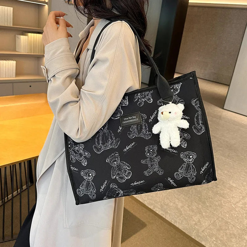 Women's black and white soft canvas tote bag with large capacity and printed rhombus pattern on front.