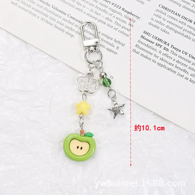 Plastic and resin fruit charm keychain with apple, strawberry designs on silver rope