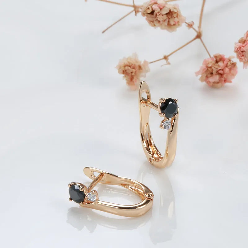 Gold-coloured women's drop earrings with black agate inlay in geometric design