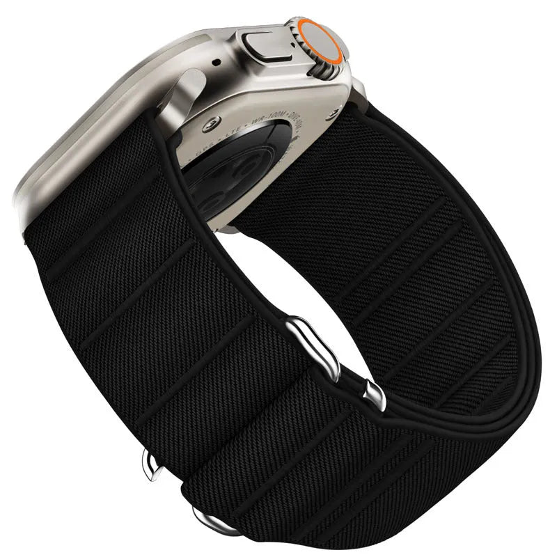Elastic nylon Apple Watch band with stainless steel buckle shown in Army Green colour on a wrist.