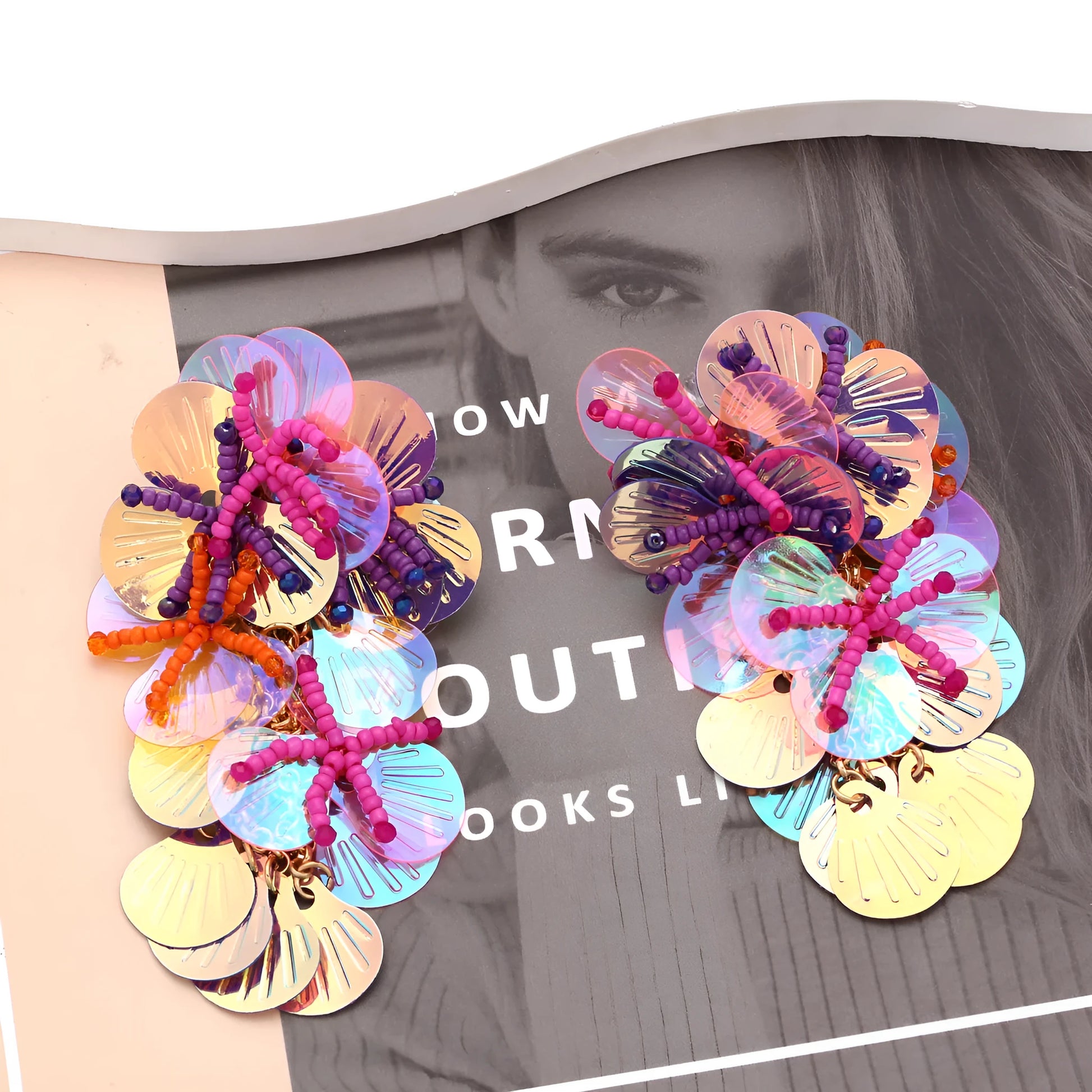 Handmade string bead flower earrings with exaggerated floral shapes in rose and purple colours, showing mixed materials and nickel-free hooks