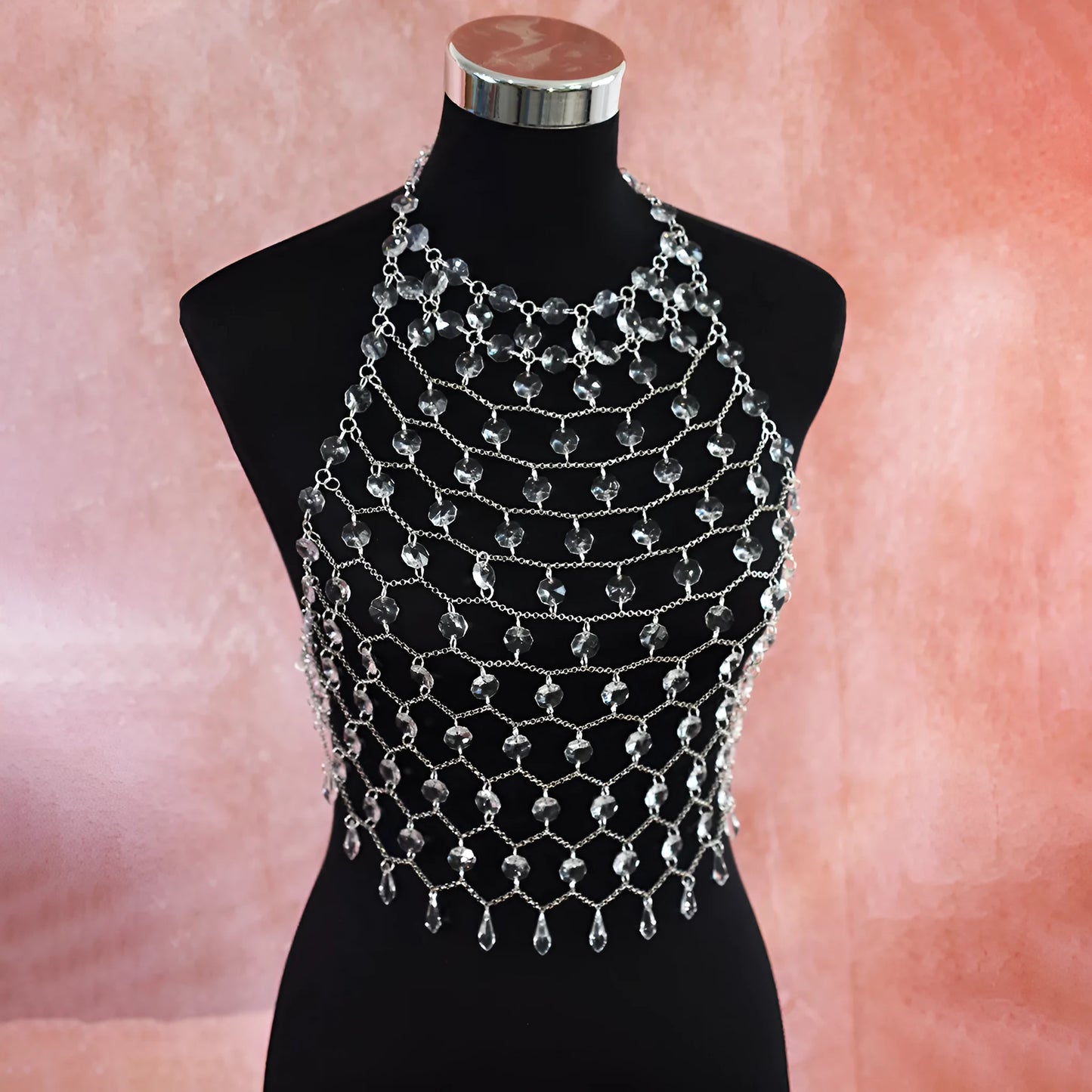 Clear acrylic crystal sequins body chain draped as a chest necklace.