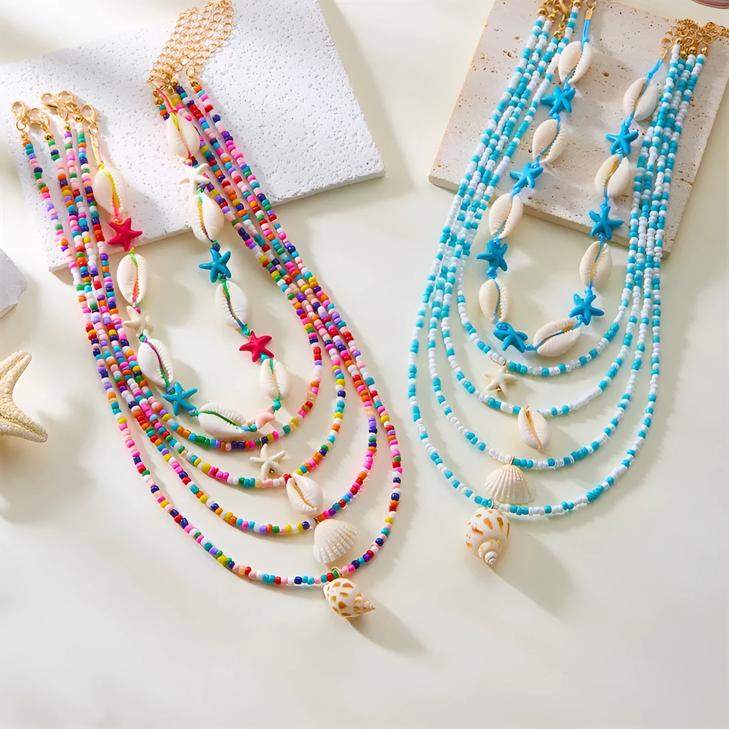 Five women's necklaces with starfish shell beads on adjustable chains in summer colours