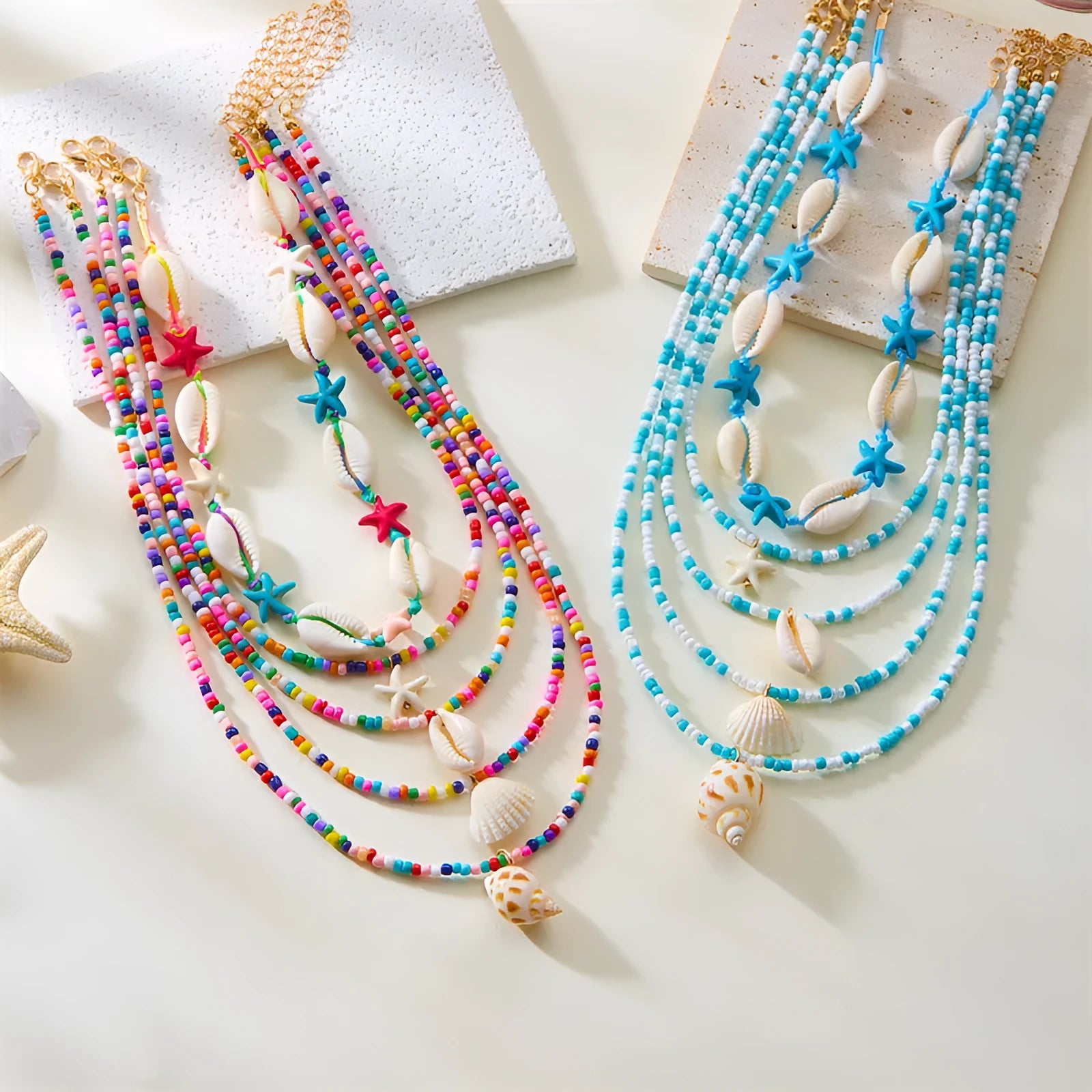 Five women's necklaces with starfish shell beads on adjustable chains in summer colours