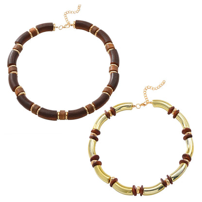 Layered bohemian jewellery set with a large round wooden pendant necklace and matching bracelet on a table.