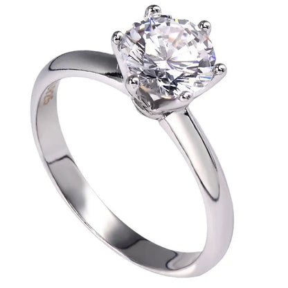 White gold plated zircon ring with six-claw setting and geometric shape on white copper base
