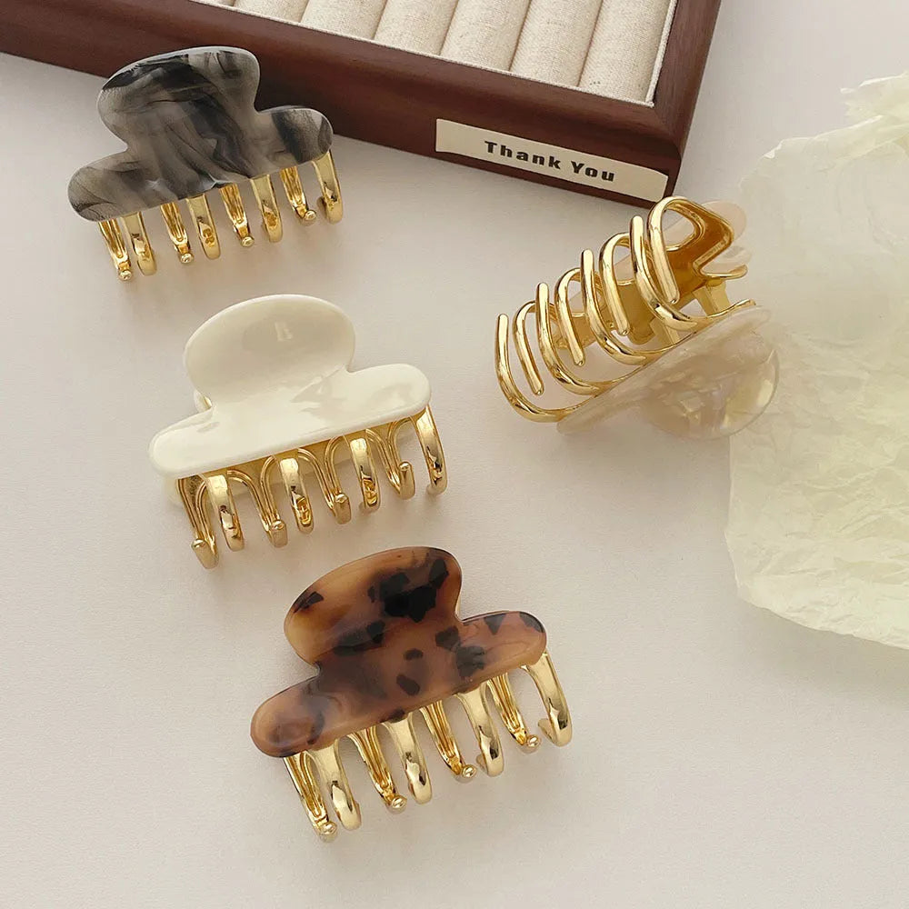 Acetate hair barrettes with metal alloy grip in leopard print, white, and ink colour options