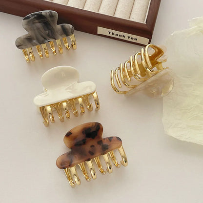 Acetate hair barrettes with metal alloy grip in leopard print, white, and ink colour options
