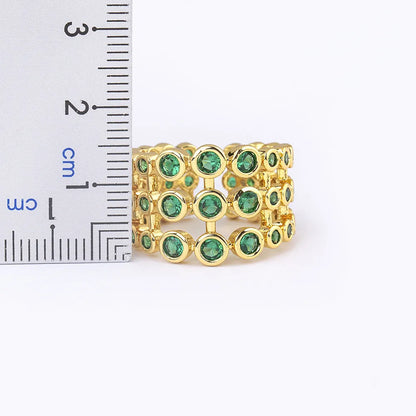 Wide gold-plated copper ring with three-layer design and a large green zircon stone.