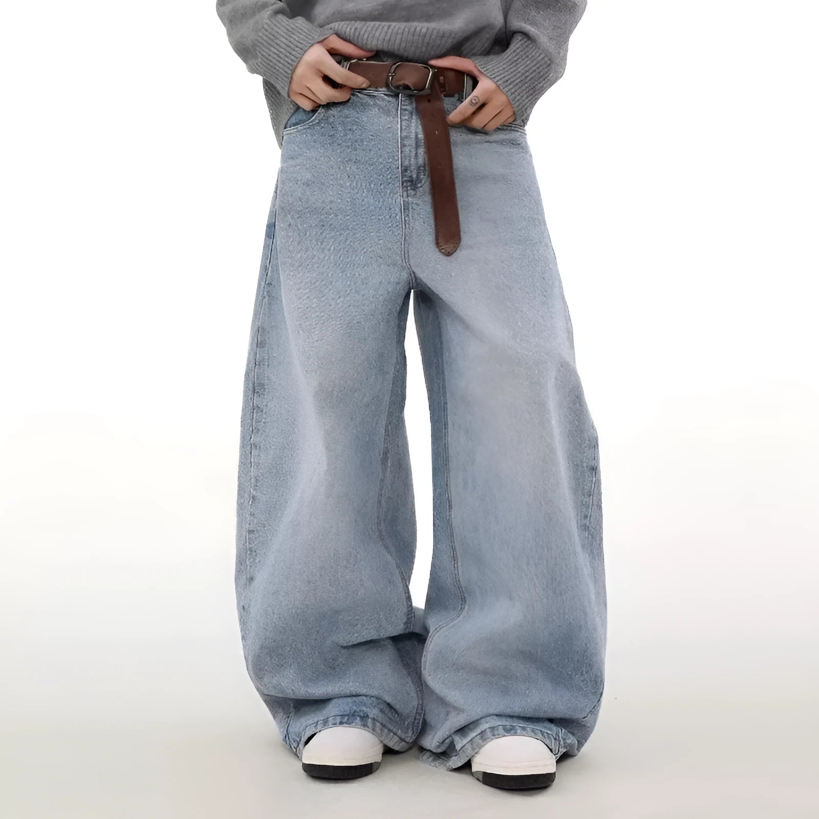 Man wearing retro blue washed straight leg distressed jeans with a mid-rise waist.