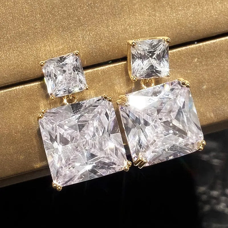 A pair of geometric square copper earrings for women in a gold colour finish.