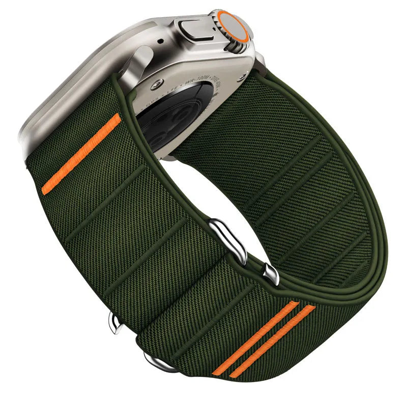 Elastic nylon Apple Watch band with stainless steel buckle shown in Army Green colour on a wrist.