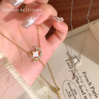 Gold star and moon zirconium necklace on a model, showing adjustable chain length.