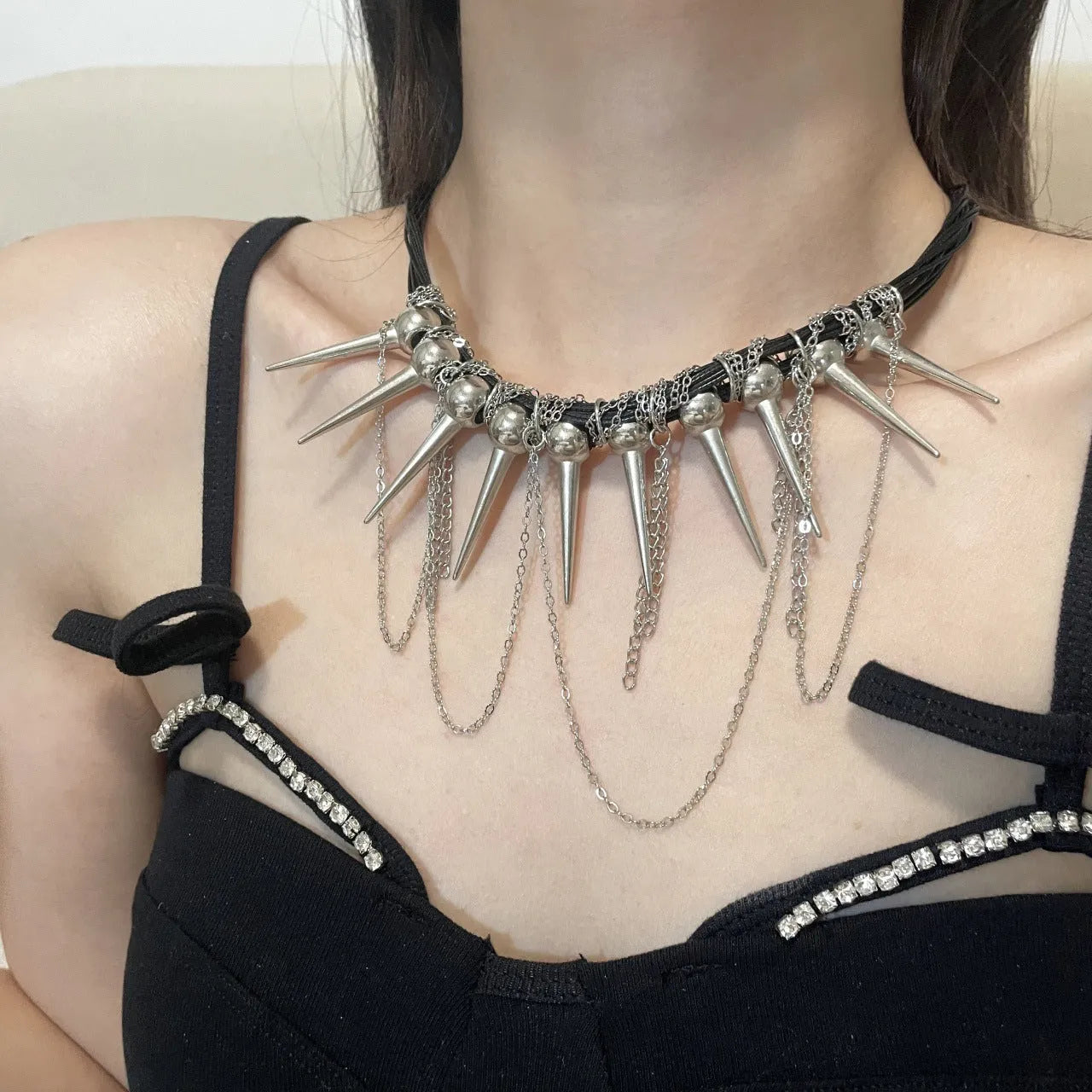 Women's casual leather necklace with winding round beads, a tassel, and decorative point rivets in pictured colour.