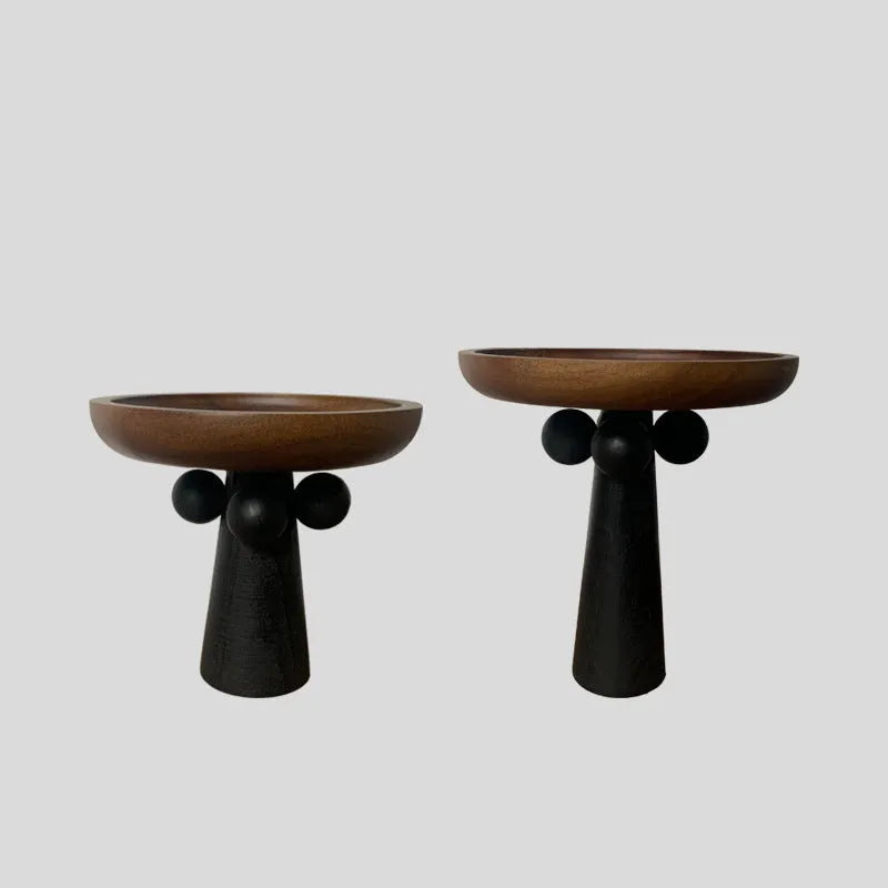 Round beech wood tray with high legs for candles and aromatherapy accessories on wooden table