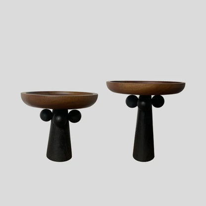 Round beech wood tray with high legs for candles and aromatherapy accessories on wooden table