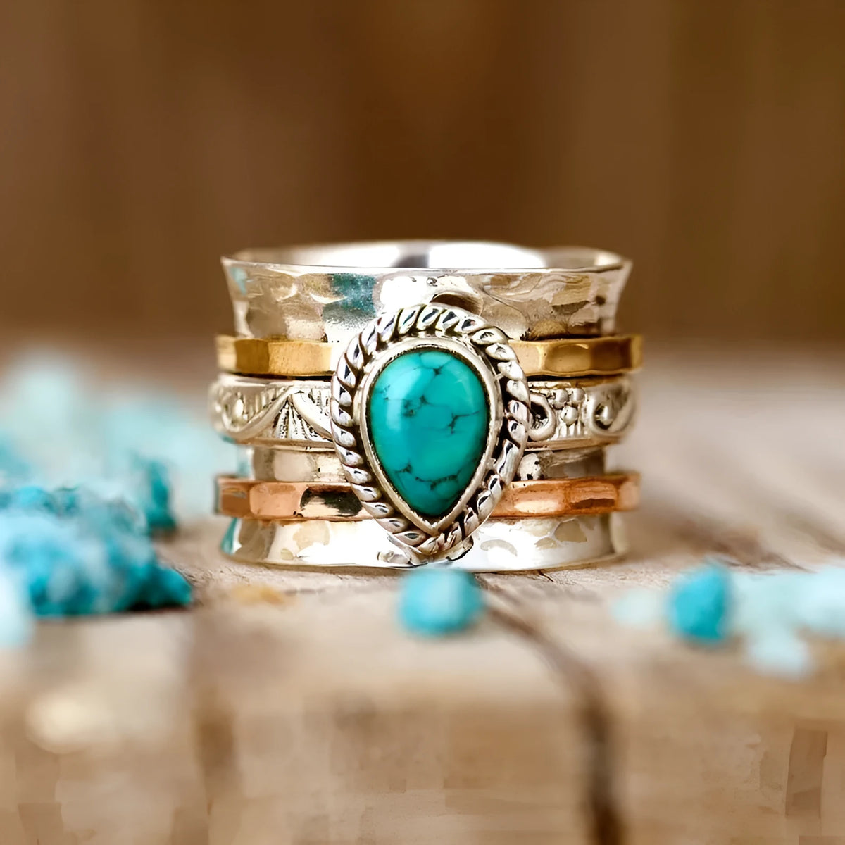 Retro green pine three-colour alloy ring for men and women on a plain background.