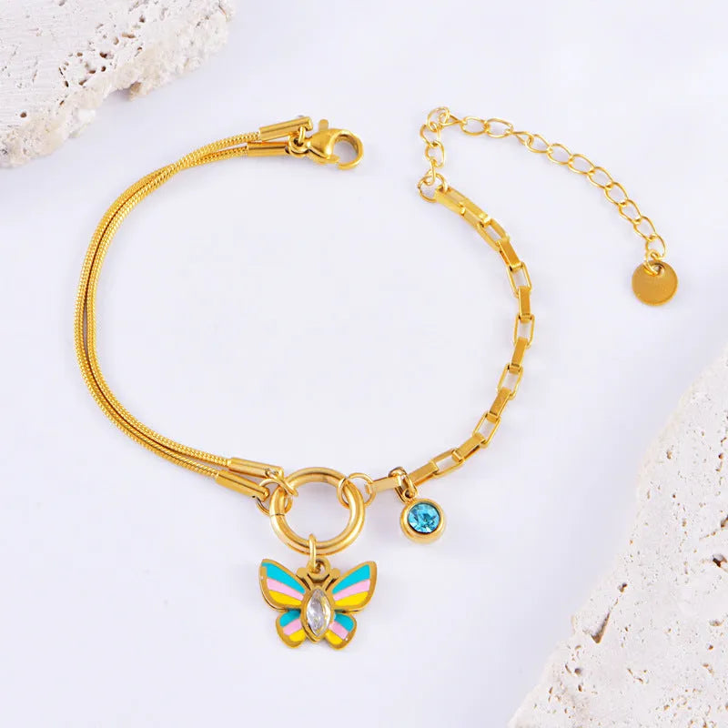 Gold-coloured titanium steel butterfly necklace and matching bracelet set on a snake bone chain.