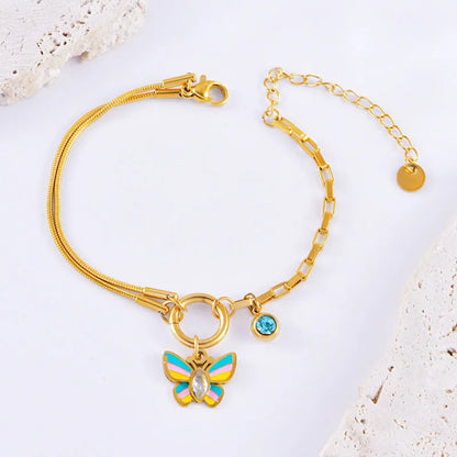 Gold-coloured titanium steel butterfly necklace and matching bracelet set on a snake bone chain.