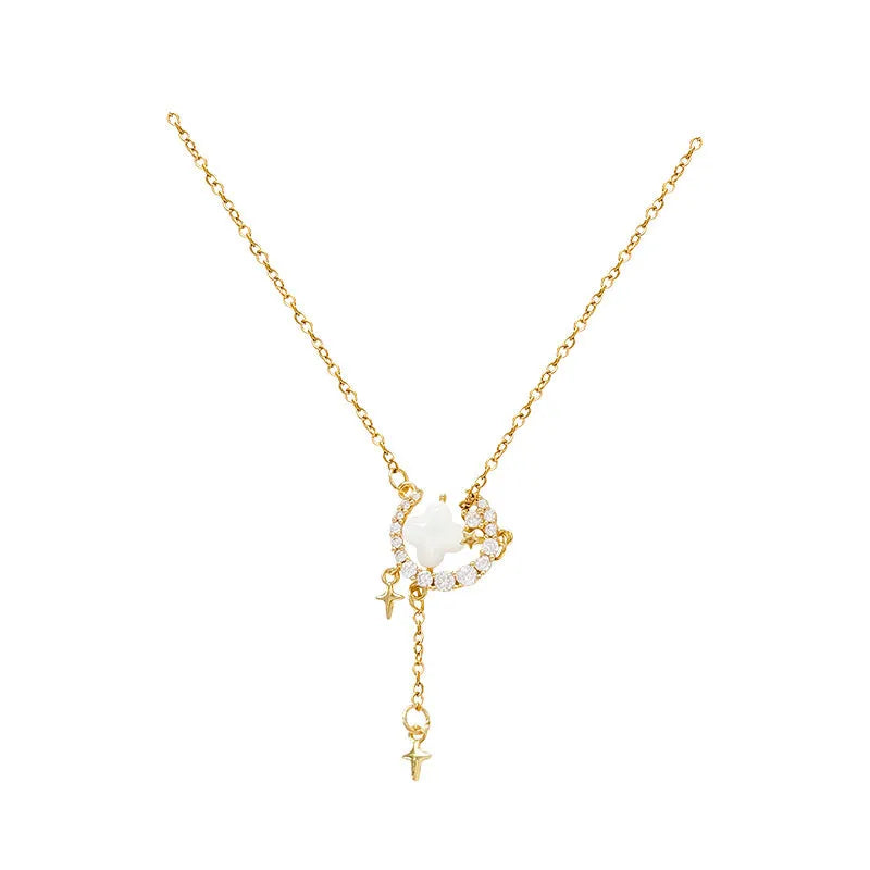 Gold star and moon zirconium necklace on a model, showing adjustable chain length.