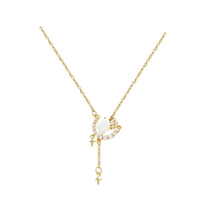 Gold star and moon zirconium necklace on a model, showing adjustable chain length.