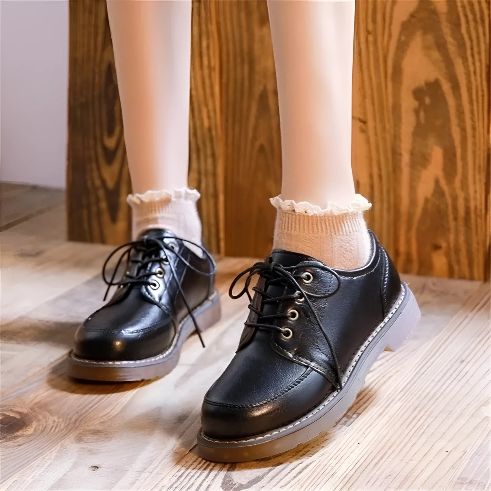 Black retro women's Mary Jane shoes with lace-up front and low square heel on a white background.