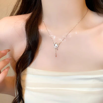 Gold star and moon zirconium necklace on a model, showing adjustable chain length.