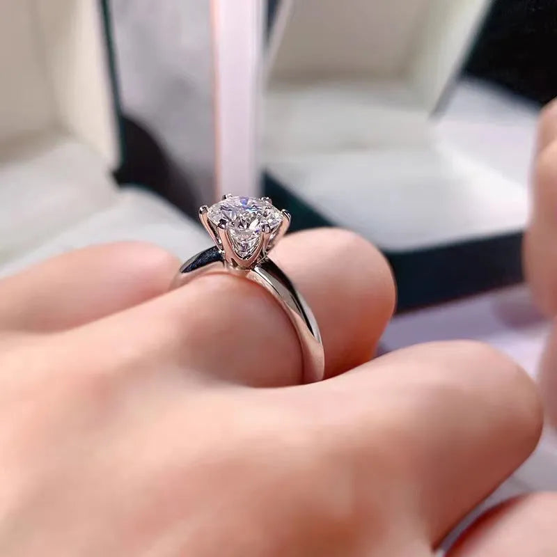 White gold plated zircon ring with six-claw setting and geometric shape on white copper base