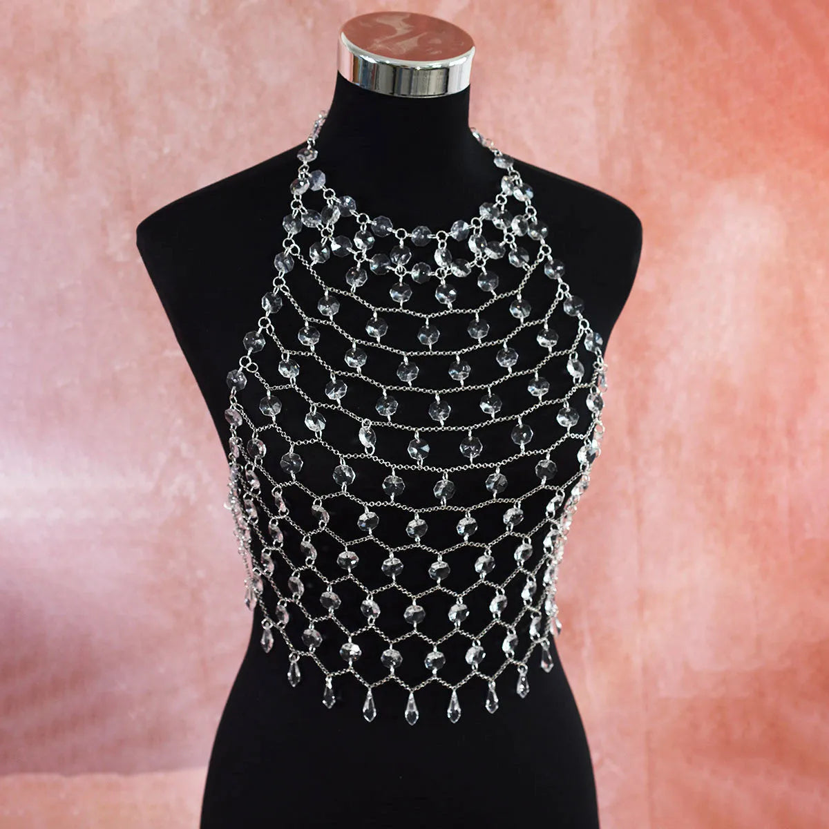 Clear acrylic crystal sequins body chain draped as a chest necklace.